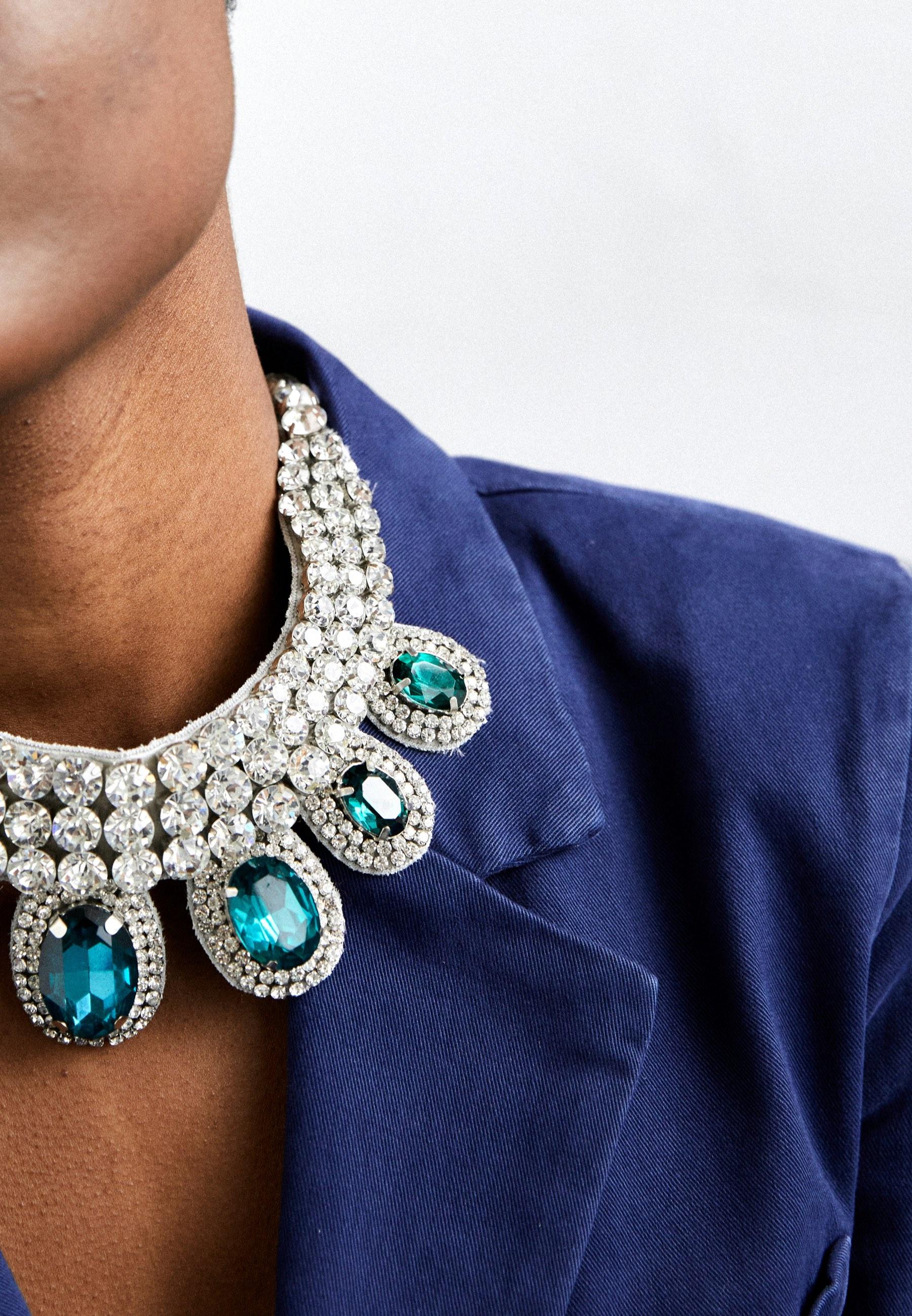 A crystal necklace on a navy blazer