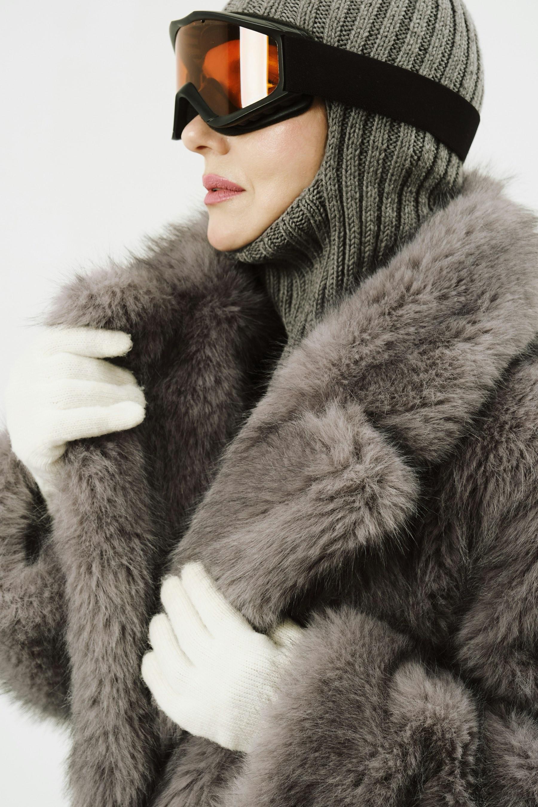 A fur coat and ski goggles