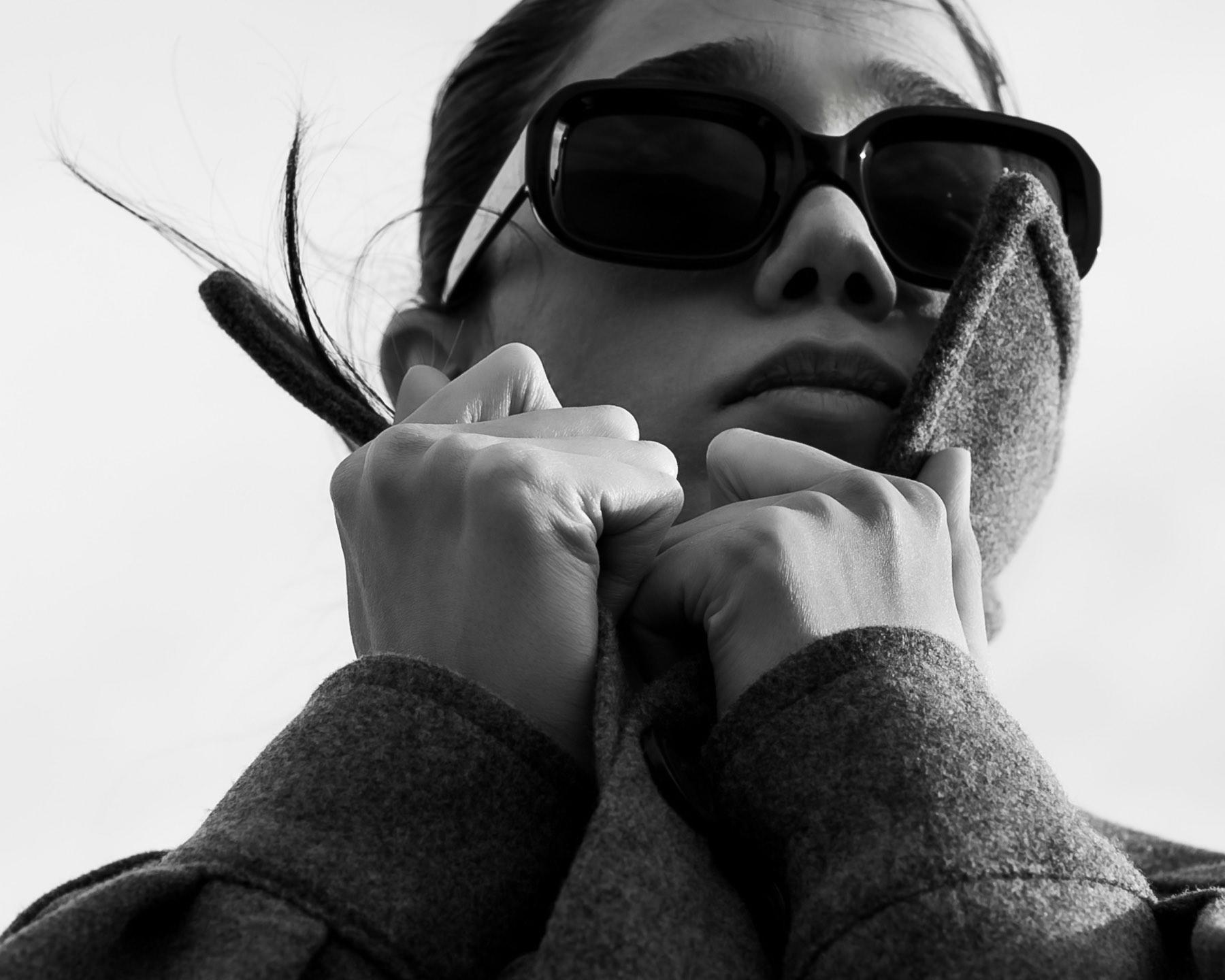 A wool coat and dark sunglasses